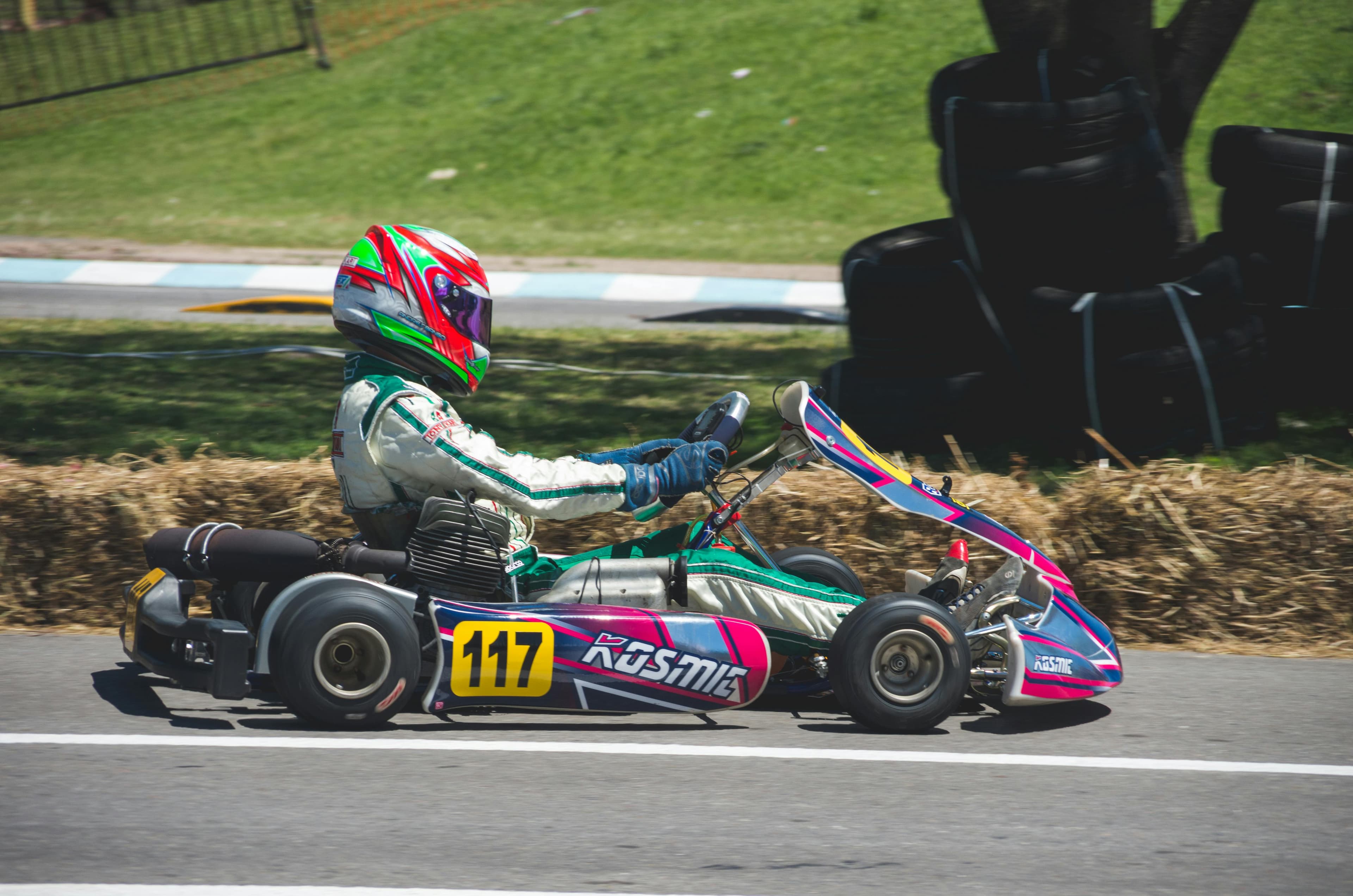 Kart racer reviewing data on a phone in the paddock